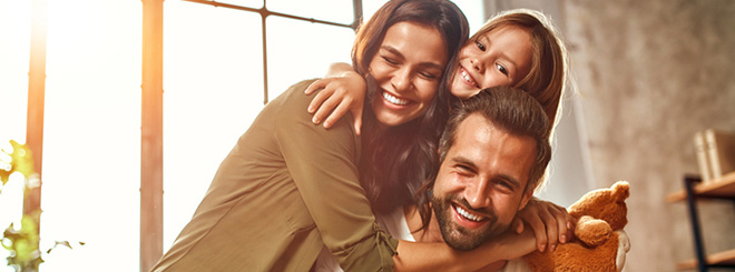 Family hugging and smiling