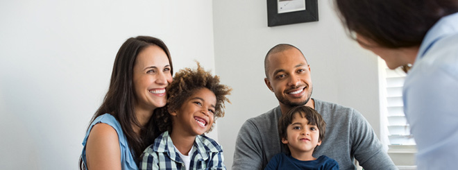 Family of four talking with advisor