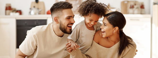 Mom and dad laughing with child