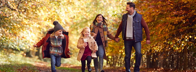 Family walking in nature in the fall