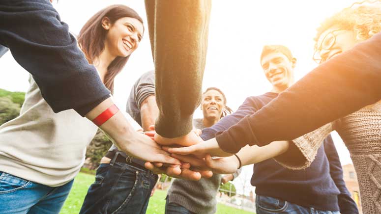 Young adults celebrating together as a team