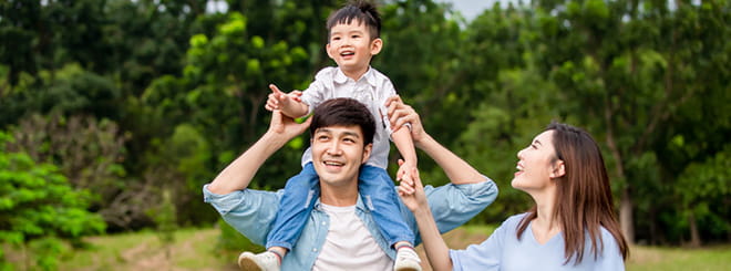 Parents with child on father's shoulders.