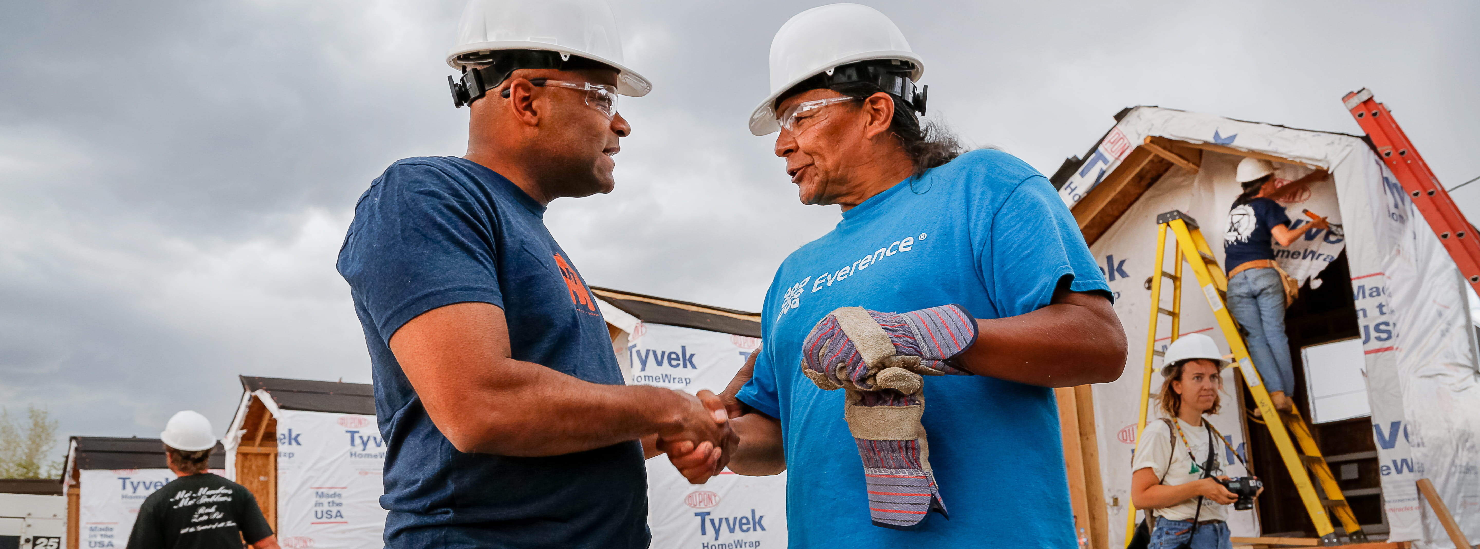 Everence employee and construction worker in front of Tiny House Village