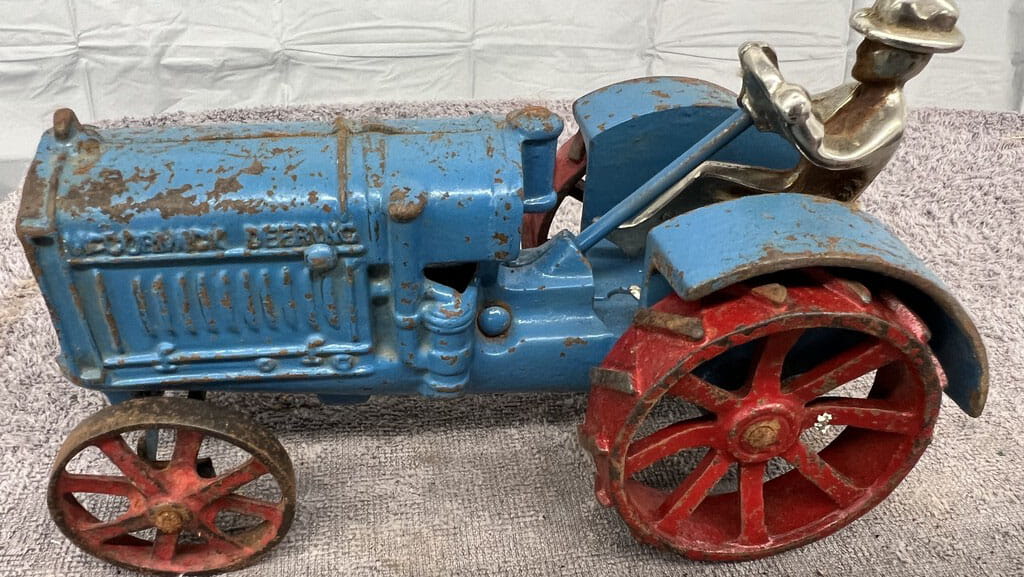 Blue antique toy tractor donated by the Nickel Family