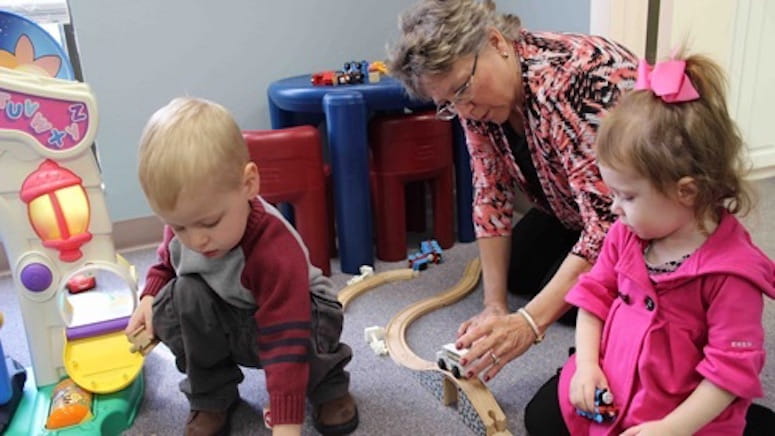 Children playing with a toy train