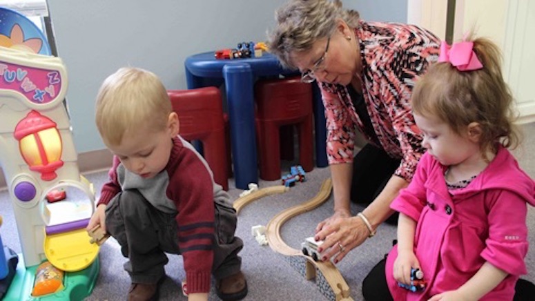 Children playing with a toy train