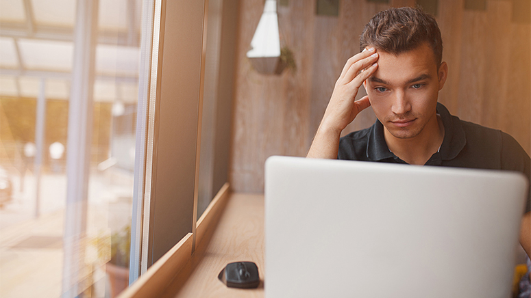 Confused young man at a coffee shop