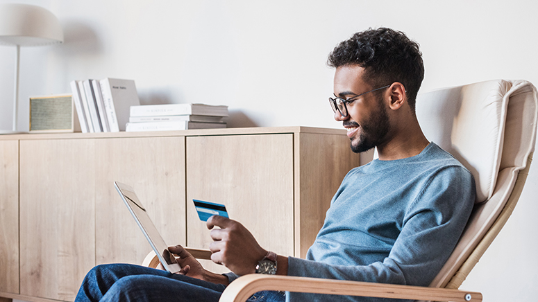 Man using tablet to shop with credit card