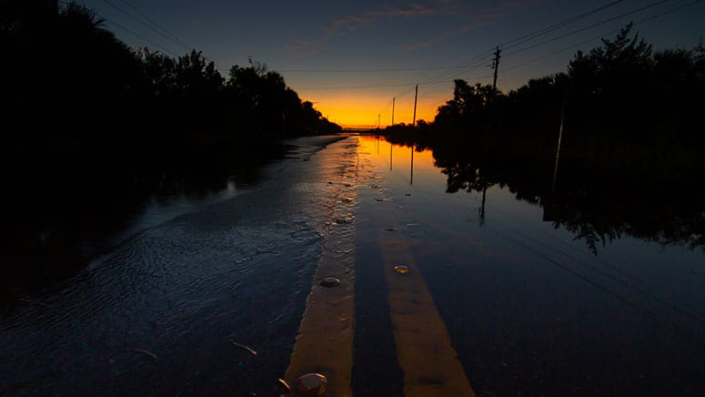 Flooded road at sunset in Florida following a hurricane.