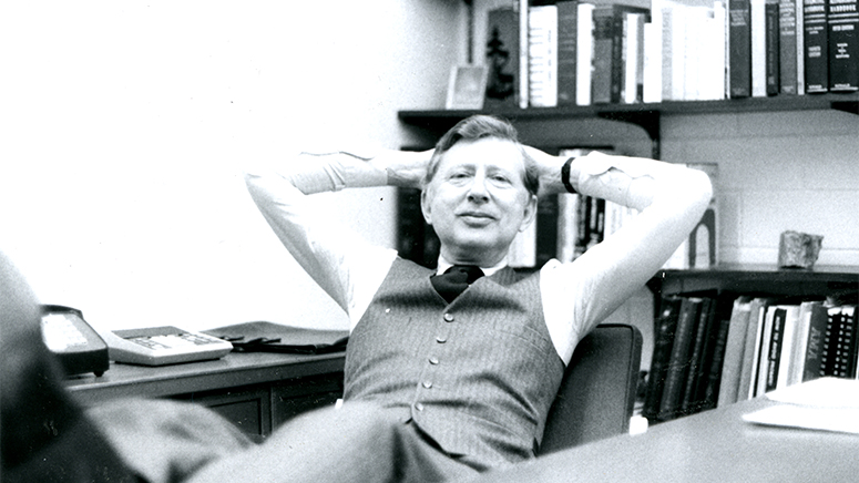 John Rudy leans back in his office chair, with pleasant, casual expression.