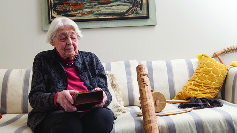 Mary on couch playing instrument