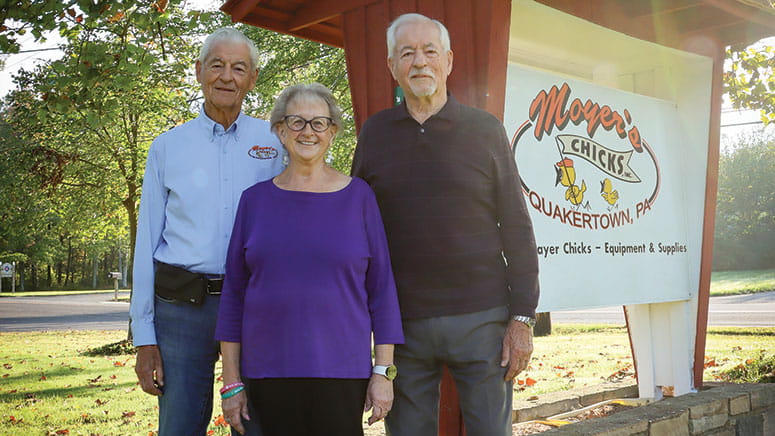 Three people smiling, posing for a photo