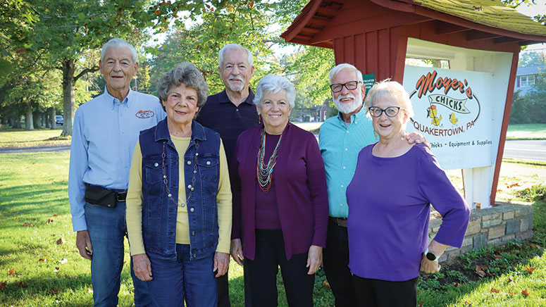 A group of people smiling, posing for a photo