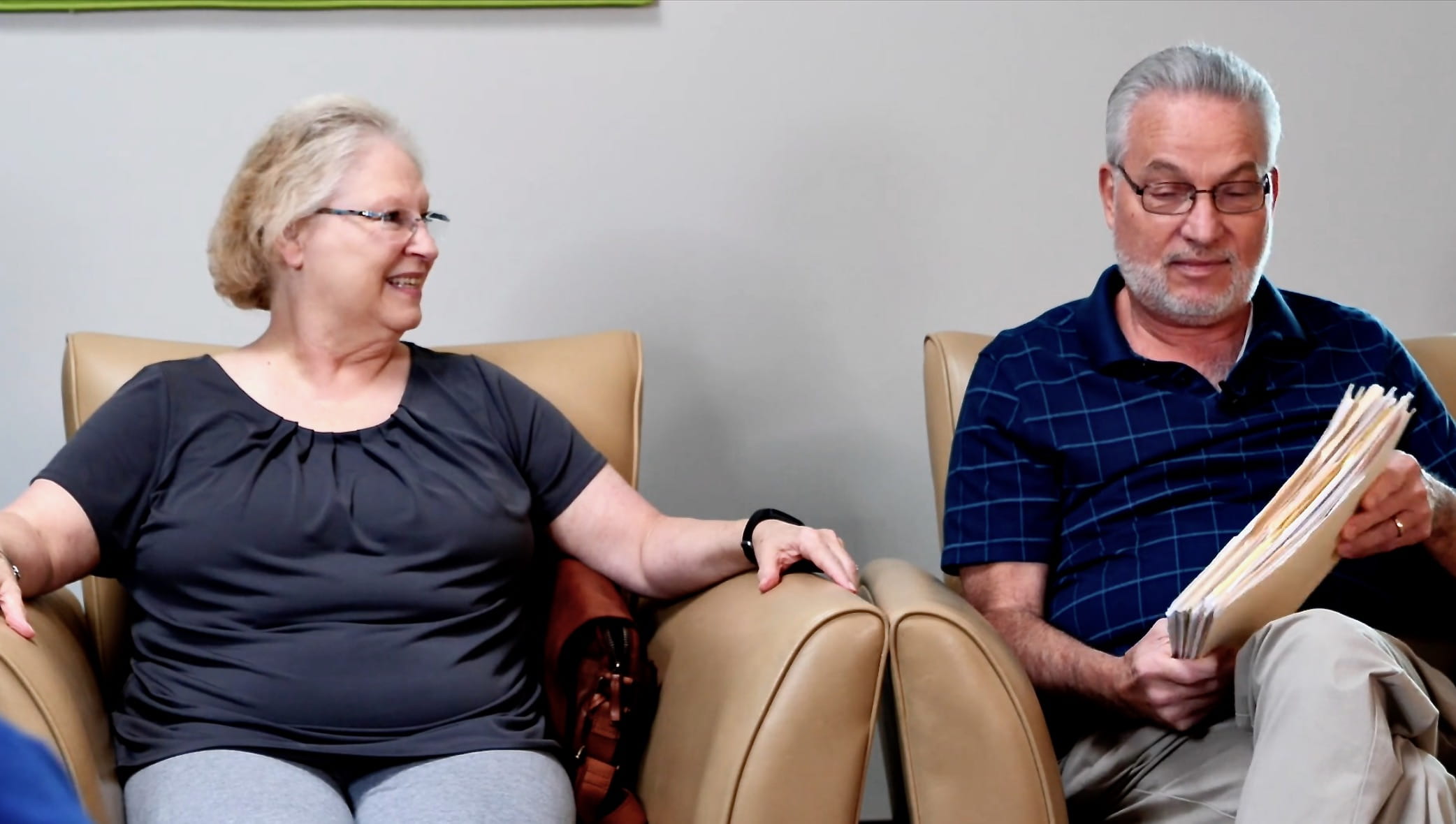 Couple looking at stacks of Medicare information