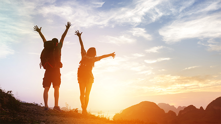 Couple hiking celebrate in sunset