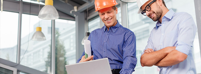 Two men looking at some construction plans