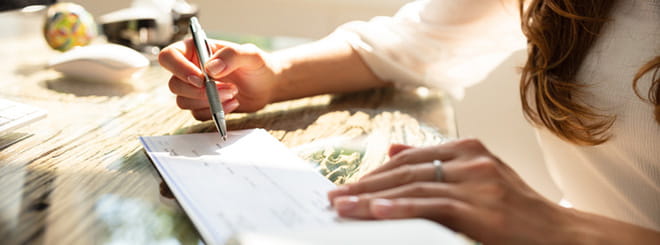 Woman signing check