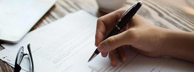 Woman signing papers