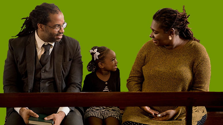 Family sitting on church pew