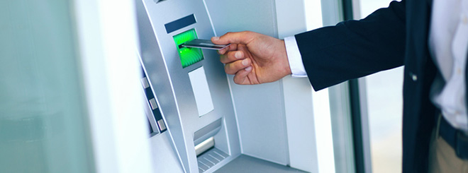 Man putting card in atm