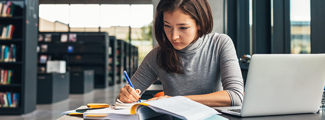 Student sitting in the library studying