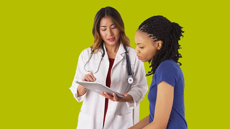 Female doctor explaining chart to female patient