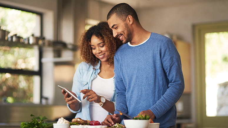 Couple looking at phone in their kitchen