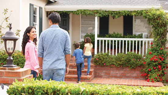 Family stepping into their new home