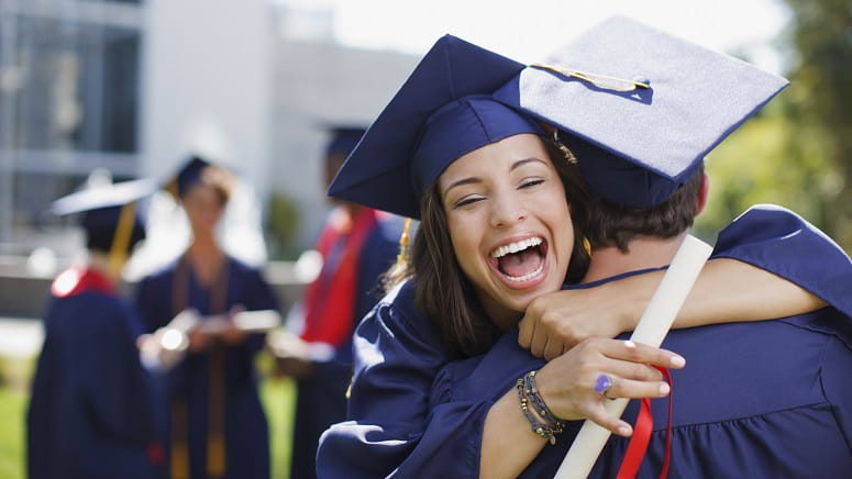 College graduates hugging