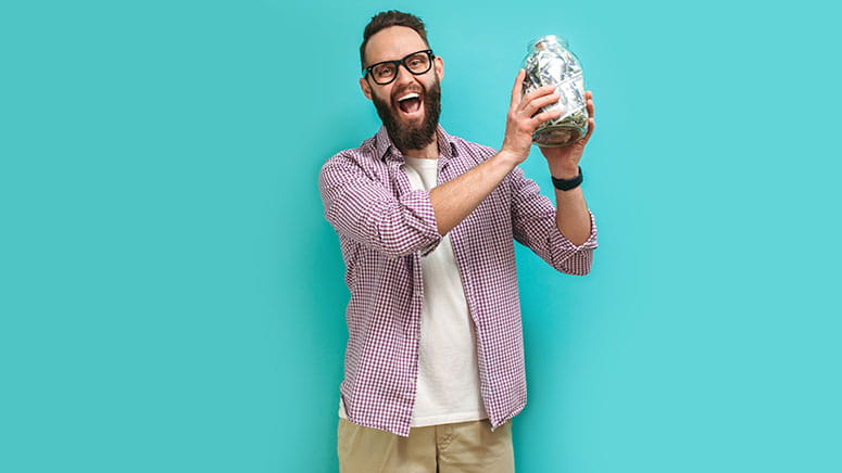 Man holding jar of cash