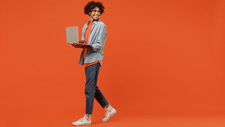 Man walking with open laptop