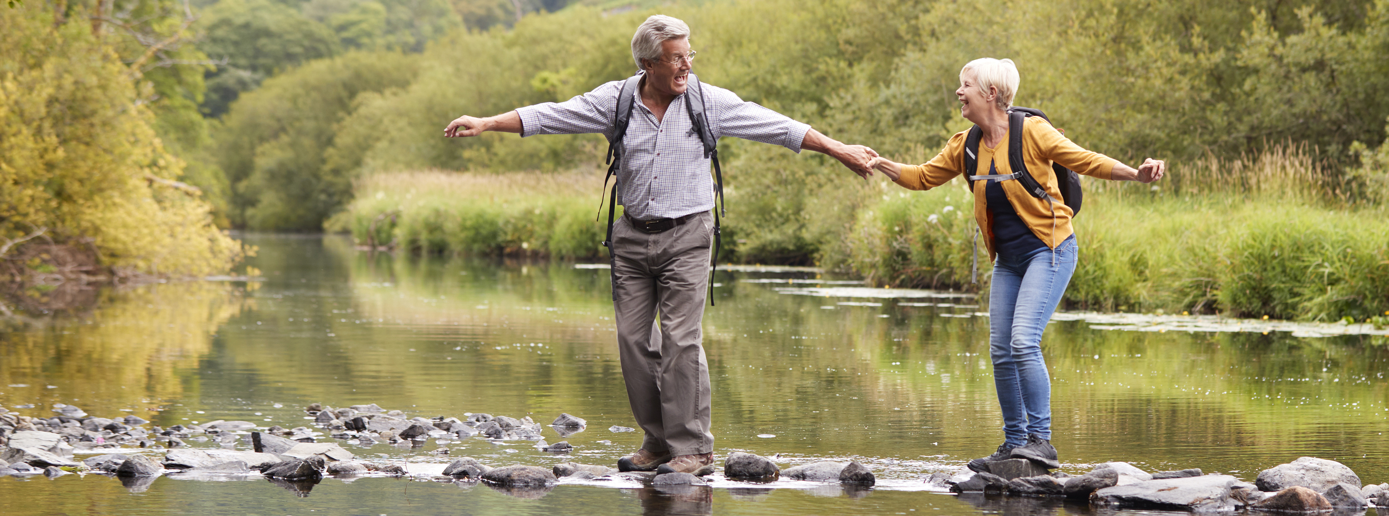 Older couple fording stream