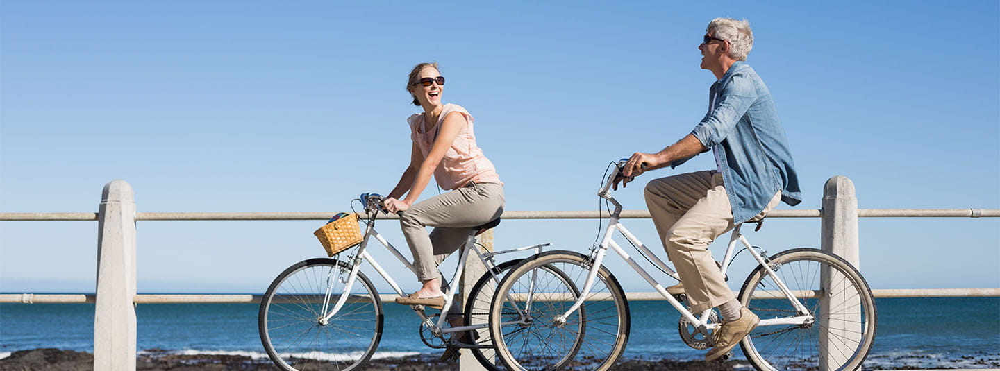 Couple biking at the beach