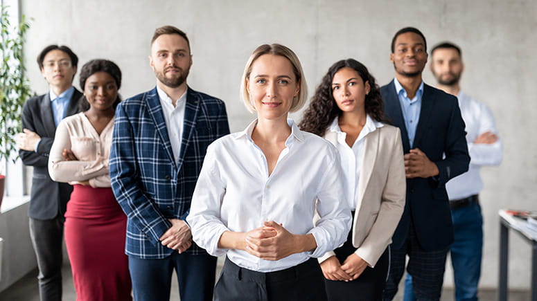 A group of professionals smile at the camera