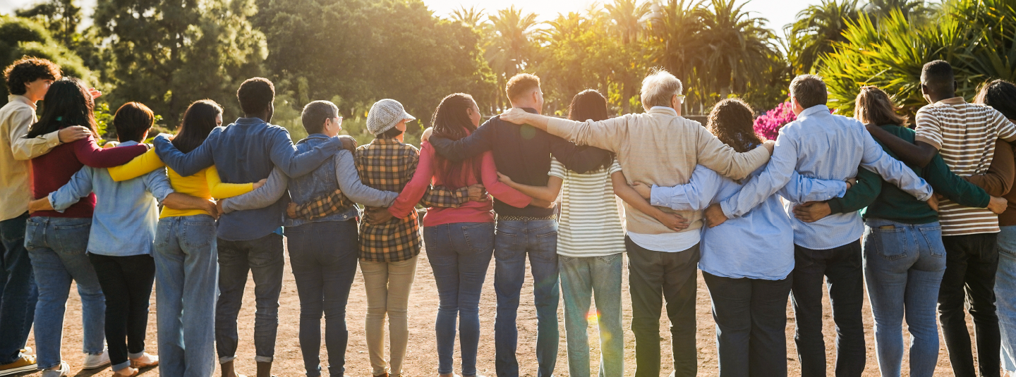 Group of people standing in a line hugging each other