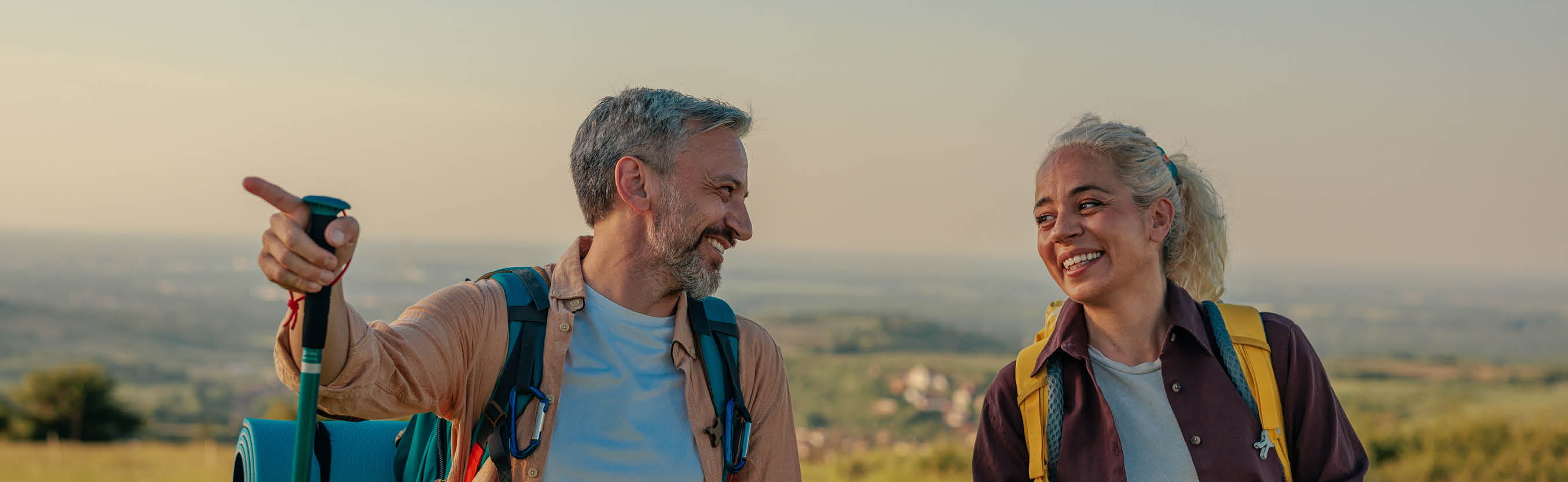 Older couple backpacking in the mountains.