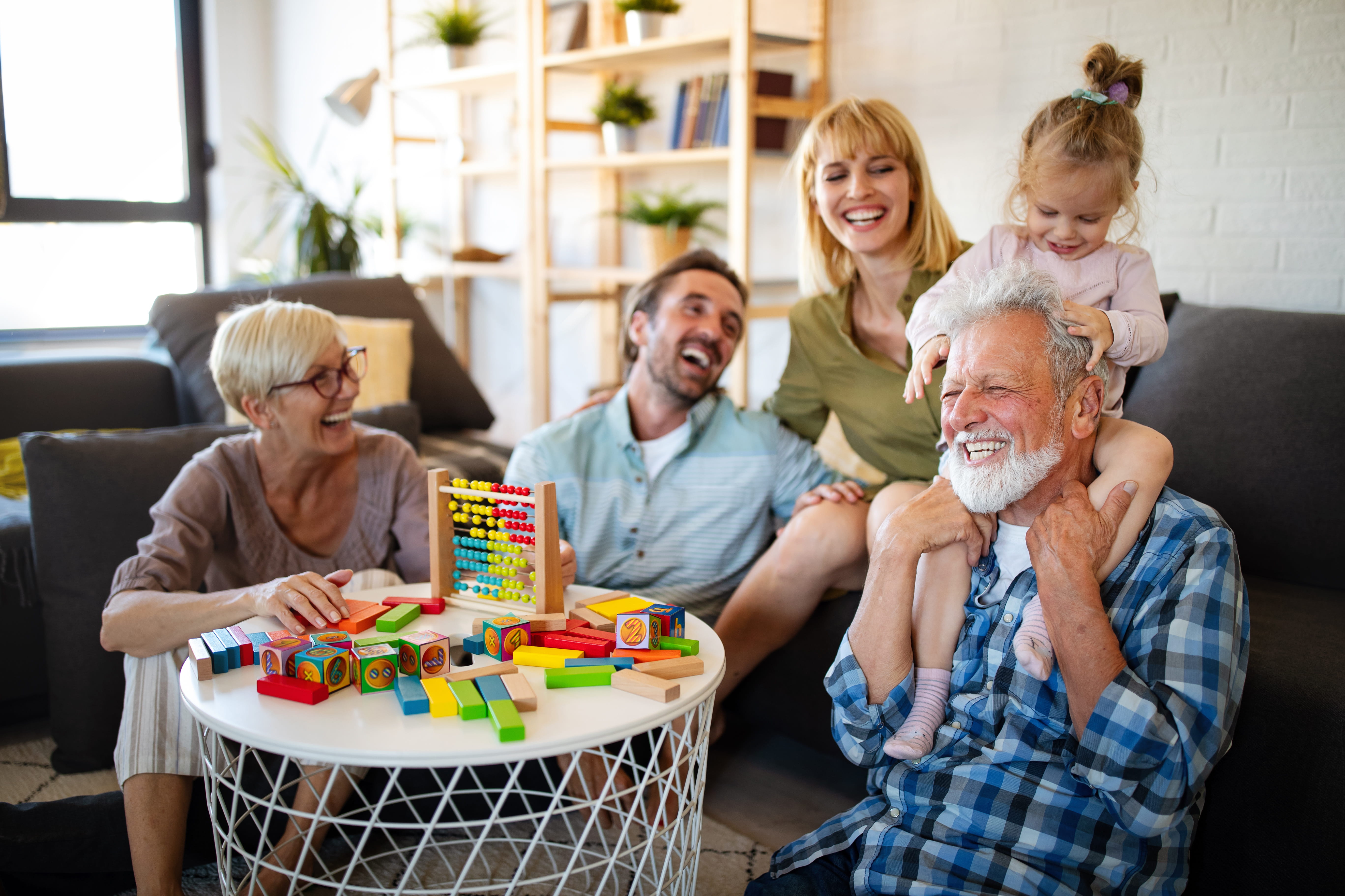 Multi-generational family playing and laughing together