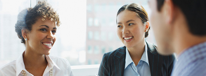 Two women smiling at man 