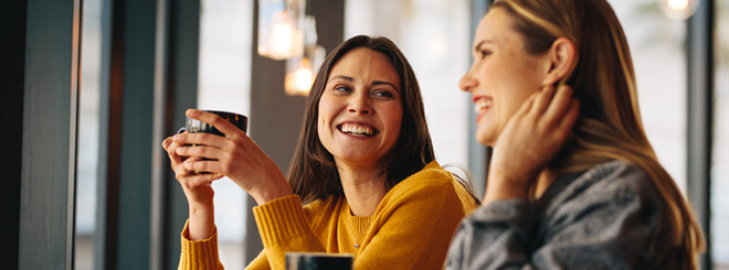 Two women chatting over coffee