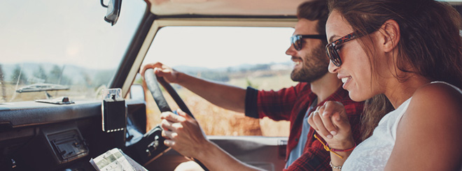 Couple in car reading map