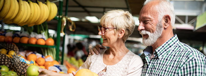 Couple picking fruit at the grocery store