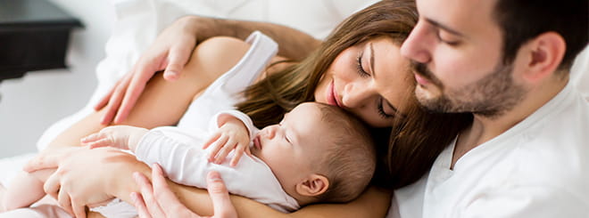 Photo of couple with newborn baby