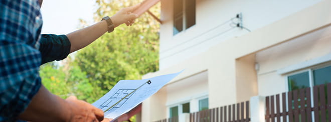 Guy looking at house plan