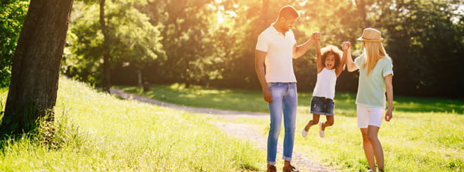 Parents swinging their child