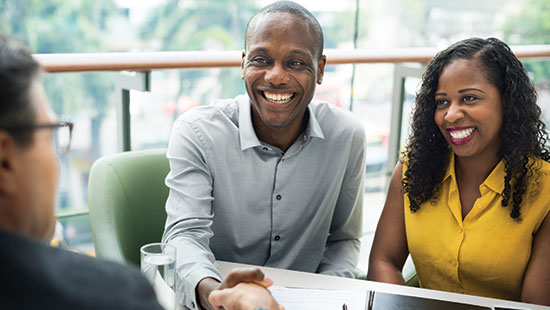 An advisor meets with a young couple to discuss Everence financial services.