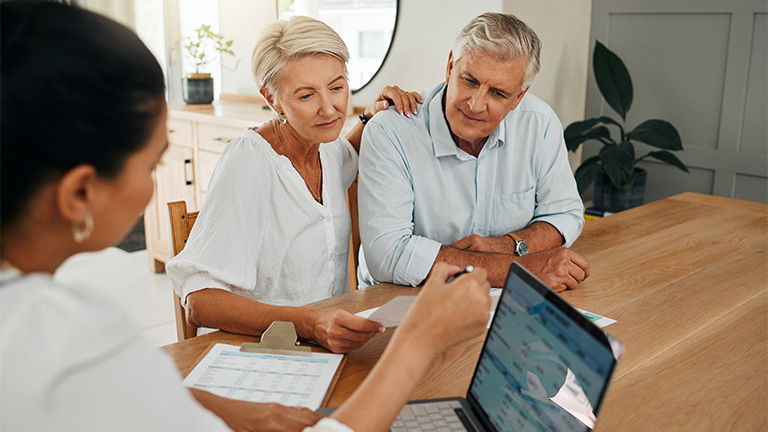 Couple sitting across table from consultant