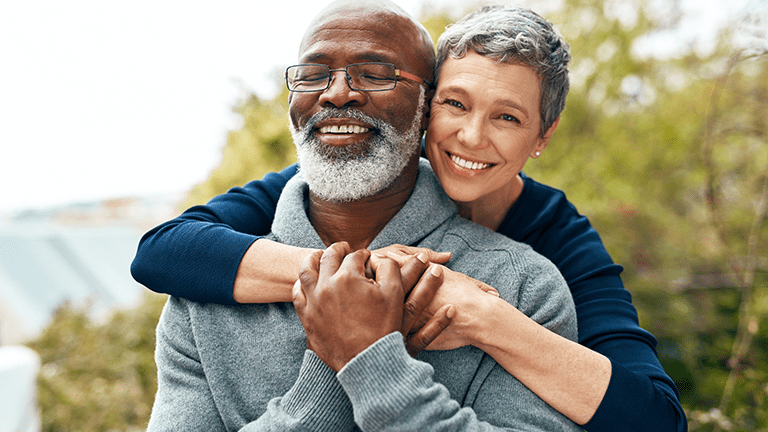 Happy couple hugging outdoors