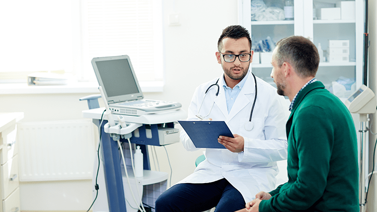 Hospital patient talking with physician