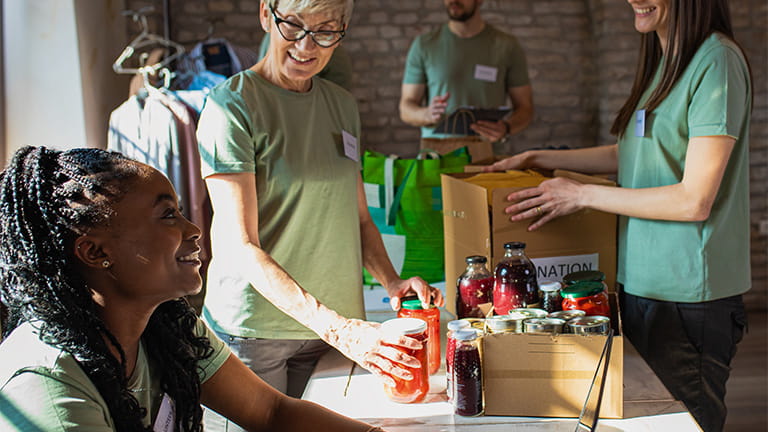 People collecting canned goods