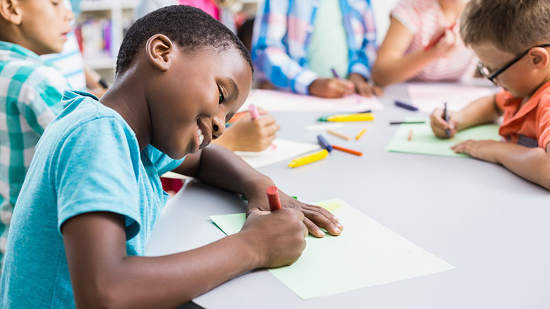 Boy coloring at table